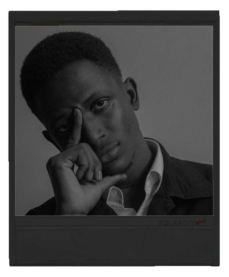 Black-and-white polaroid portrait of Samuel Wambugu with his hand resting on his face